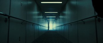 Movie still from “The Imposter” (2012), directed by Bart Layton – An empty hallway with a bright light coming from the window; Extreme Wide shot, Low angle