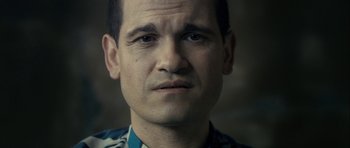 Movie still from “The Imposter” (2012), directed by Bart Layton – A person wearing a floral shirt; Close Up shot, Low angle