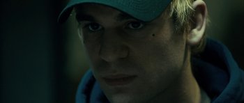 Movie still from “The Imposter” (2012), directed by Bart Layton – A person wearing a hat; Extreme Close Up shot, Over the shoulder angle