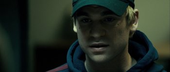Movie still from “The Imposter” (2012), directed by Bart Layton – A person wearing a hat; Close Up shot, Over the shoulder angle
