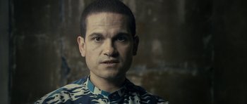 Movie still from “The Imposter” (2012), directed by Bart Layton – A person wearing a camouflage shirt; Close Up shot, Over the shoulder angle