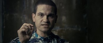 Movie still from “The Imposter” (2012), directed by Bart Layton – A person wearing a camouflage shirt; Close Up shot, Over the shoulder angle