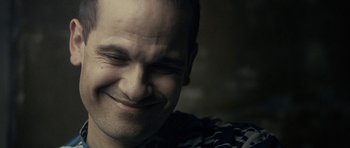 Movie still from “The Imposter” (2012), directed by Bart Layton – A man smiling with his eyes closed; Close Up shot, Low angle