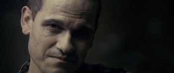 Movie still from “The Imposter” (2012), directed by Bart Layton – A man's face in the dark; Close Up shot, Over the shoulder angle