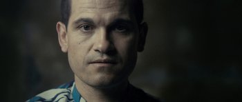 Movie still from “The Imposter” (2012), directed by Bart Layton – A person wearing a shirt; Close Up shot, Low angle