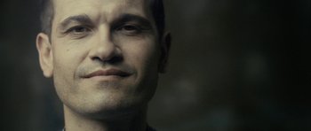 Movie still from “The Imposter” (2012), directed by Bart Layton – A man's face in a dark room; Close Up shot, Low angle