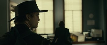 Movie still from “The Imposter” (2012), directed by Bart Layton – A man wearing a hat is looking out the window; Close Up shot, Over the shoulder angle