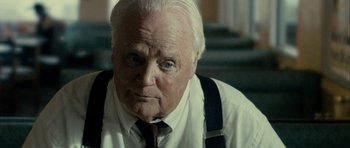 Movie still from “The Imposter” (2012), directed by Bart Layton – An older man wearing a white shirt and a tie; Close Up shot, Over the shoulder angle