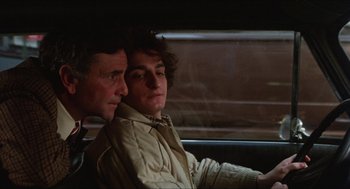 Movie still from “The In-Laws” (1979), directed by Arthur Hiller – Two men sitting in the back seat of a car; Close Up shot, Over the shoulder angle