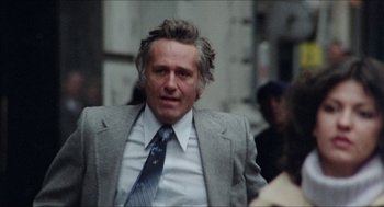Movie still from “The In-Laws” (1979), directed by Arthur Hiller – A person wearing a suit and tie; Medium shot, Low angle