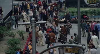 Movie still from “The In-Laws” (1979), directed by Arthur Hiller – A crowd of people walking down a street; Extreme Wide shot, High angle