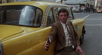Movie still from “The In-Laws” (1979), directed by Arthur Hiller – A man sitting next to a yellow taxi cab; Medium shot, Low angle