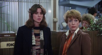 Movie still from “The In-Laws” (1979), directed by Arthur Hiller – Two women standing next to each other in front of a counter; Medium shot, Over the shoulder angle
