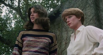 Movie still from “The In-Laws” (1979), directed by Arthur Hiller – Two women standing next to each other in front of a tree; Medium shot, Low angle