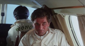 Movie still from “The In-Laws” (1979), directed by Arthur Hiller – A person wearing a white shirt; Close Up shot, Over the shoulder angle