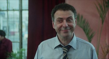 Movie still from “The In-Laws” (1979), directed by Arthur Hiller – A person wearing a shirt and a tie; Close Up shot, Low angle