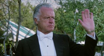 Movie still from “The In-Laws” (1979), directed by Arthur Hiller – An older man wearing a tuxedo and a bow tie; Close Up shot, Low angle