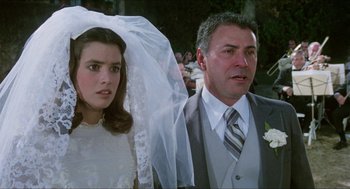 Movie still from “The In-Laws” (1979), directed by Arthur Hiller – A man and a woman in wedding attire; Close Up shot, Over the shoulder angle
