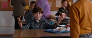 Movie still from “The Incredible Burt Wonderstone” (2013), directed by Don Scardino – A boy sitting at a table with food in front of him; Medium shot, Over the shoulder angle