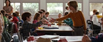 Movie still from “The Incredible Burt Wonderstone” (2013), directed by Don Scardino – A group of people sitting at a table with food; Medium shot, Over the shoulder angle