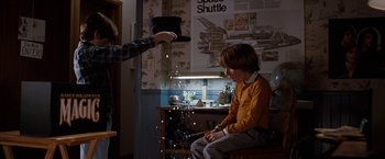 Movie still from “The Incredible Burt Wonderstone” (2013), directed by Don Scardino – A man is performing tricks on a young boy; Medium shot, Over the shoulder angle