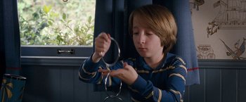 Movie still from “The Incredible Burt Wonderstone” (2013), directed by Don Scardino – A young boy holding a pair of hula hoops; Close Up shot, Over the shoulder angle