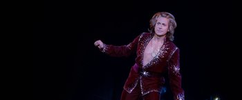Movie still from “The Incredible Burt Wonderstone” (2013), directed by Don Scardino – A man in a red velvet suit is dancing on a stage; Medium shot, Low angle