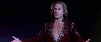 Movie still from “The Incredible Burt Wonderstone” (2013), directed by Don Scardino – A man with long blonde hair wearing a red jacket; Close Up shot, Low angle