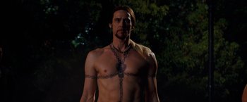 Movie still from “The Incredible Burt Wonderstone” (2013), directed by Don Scardino – A shirtless man with a chain around his neck; Medium shot, Low angle