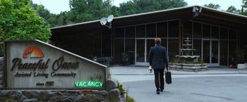 Movie still from “The Incredible Burt Wonderstone” (2013), directed by Don Scardino – A man walking down a street holding a suitcase; Wide shot, Low angle