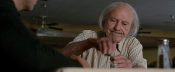 Movie still from “The Incredible Burt Wonderstone” (2013), directed by Don Scardino – An older man is sitting at a table; Close Up shot, Low angle