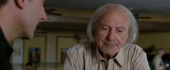 Movie still from “The Incredible Burt Wonderstone” (2013), directed by Don Scardino – An older man with white hair looking down; Close Up shot, Over the shoulder angle
