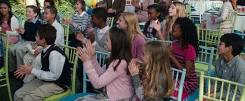 Movie still from “The Incredible Burt Wonderstone” (2013), directed by Don Scardino – A group of young people clapping at an outdoor event; Medium shot, Over the shoulder angle