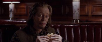 Movie still from “The Incredible Burt Wonderstone” (2013), directed by Don Scardino – A man sitting in a booth eating a sandwich; Close Up shot, Over the shoulder angle