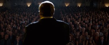 Movie still from “The Incredible Burt Wonderstone” (2013), directed by Don Scardino – A crowd of people watching a man in a black suit; Wide shot, Over the shoulder angle
