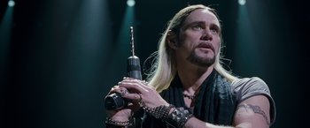 Movie still from “The Incredible Burt Wonderstone” (2013), directed by Don Scardino – A man with long blonde hair holding an electric drill; Close Up shot, Over the shoulder angle