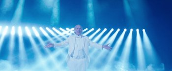 Movie still from “The Incredible Burt Wonderstone” (2013), directed by Don Scardino – A man in a white suit standing in front of lights; Wide shot, Low angle