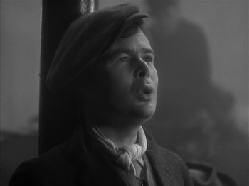 Movie still from “The Informer” (1935), directed by John Ford – A black and white photo of a man wearing a hat; Close Up shot, Low angle