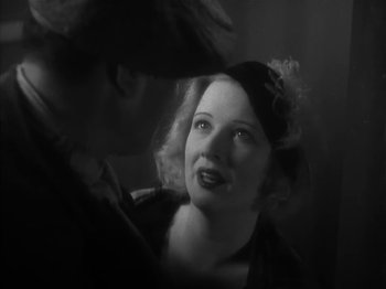 Movie still from “The Informer” (1935), directed by John Ford – A man and a woman are looking at one another; Close Up shot, Low angle