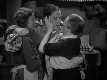 Movie still from “The Informer” (1935), directed by John Ford – A group of people that are standing up together; Medium shot, Over the shoulder angle