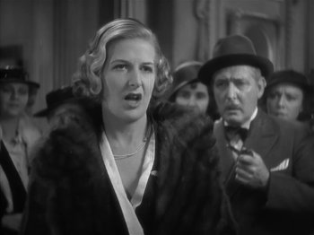 Movie still from “The Informer” (1935), directed by John Ford – An old photo of a woman in a fur coat; Close Up shot, Low angle