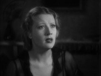 Movie still from “The Informer” (1935), directed by John Ford – A black - and - white photo of a woman looking at the camera; Close Up shot, High angle