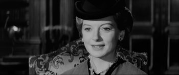 Movie still from “The Innocents” (1961), directed by Jack Clayton – An old photo of a woman wearing a hat; Close Up shot, Over the shoulder angle