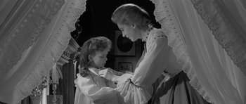 Movie still from “The Innocents” (1961), directed by Jack Clayton – An older woman and a young girl are looking at each other; Medium shot, Over the shoulder angle
