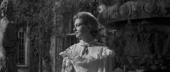 Movie still from “The Innocents” (1961), directed by Jack Clayton – A black - and - white photo of a woman in an old - fashioned dress; Medium shot, Low angle