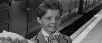 Movie still from “The Innocents” (1961), directed by Jack Clayton – A young boy wearing a suit and a tie; Close Up shot, High angle