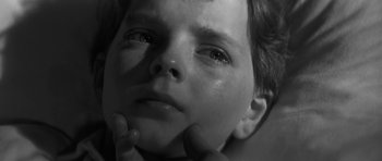 Movie still from “The Innocents” (1961), directed by Jack Clayton – A child's face in black - and - white; Close Up shot, High angle