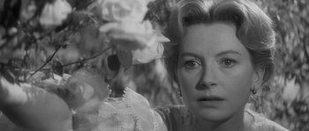 Movie still from “The Innocents” (1961), directed by Jack Clayton – Black and white photograph of a woman looking at flowers; Close Up shot, Over the shoulder angle