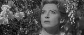 Movie still from “The Innocents” (1961), directed by Jack Clayton – An old black and white photo of a woman looking up; Close Up shot, Low angle