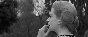 Movie still from “The Innocents” (1961), directed by Jack Clayton – A black - and - white photo of a woman with her finger in her mouth; Close Up shot, Low angle